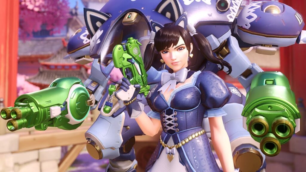 D.Va in blue dress with a green gun stands confidently beside a large blue mech adorned with cat ears