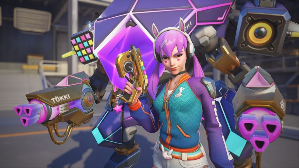 D.Va with pink hair and headphones stands confidently, holding a gold gun
