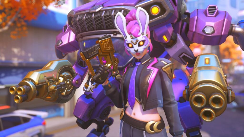 D.Va in a bunny mask with a pink mohawk holds a golden gun, standing confidently in front of a large purple mech