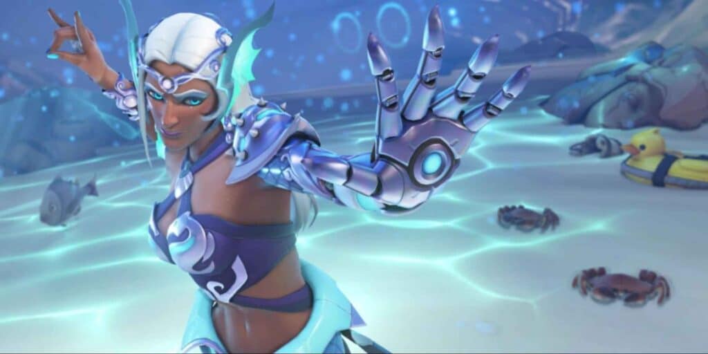 Symmetra poses confidently in aquatic armor, with a robotic arm extended. Fish, crabs, and a rubber duck float in the glowing water. Energetic mood.