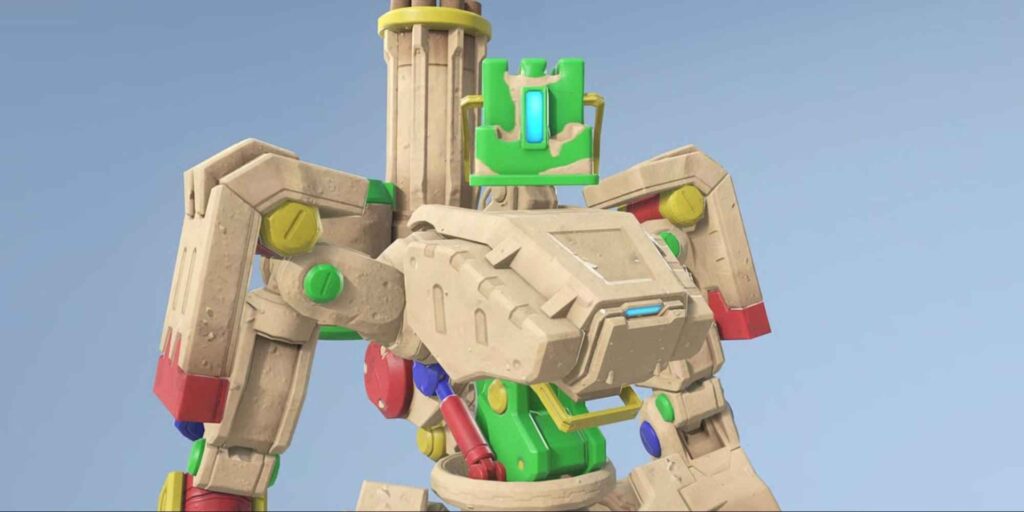 A colorful, stylized Overwatch 2 character with a boxy design, featuring various geometric shapes and bright accents against a blue background.