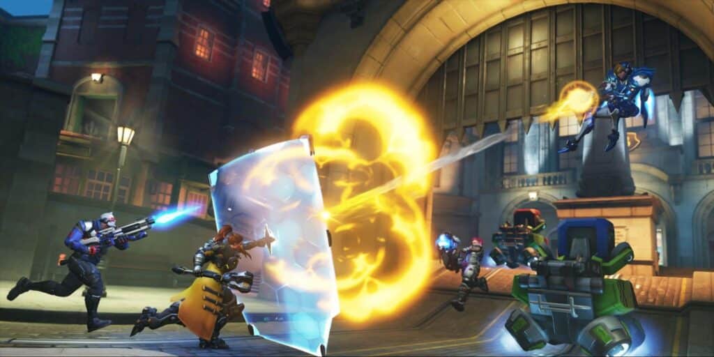 Overwatch 2 heroes battling near a shield with Pharah firing rockets from above
